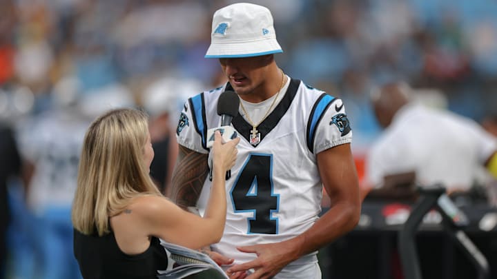 Aug 21, 2025; Charlotte, North Carolina, USA; Carolina Panthers wide receiver Tetairoa McMillan (4) does a sideline interview during the first half against the Pittsburgh Steelers at Bank of America Stadium.