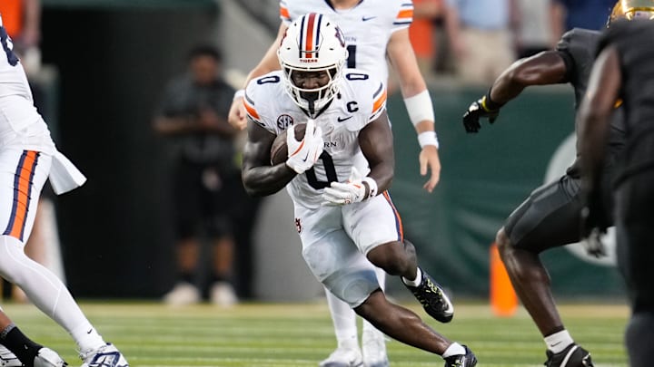 Aug 29, 2025; Waco, Texas, USA;  Auburn Tigers running back Damari Alston (0) runs the ball against the Baylor Bears during the first half at McLane Stadium. Mandatory Credit: Chris Jones-Imagn Images