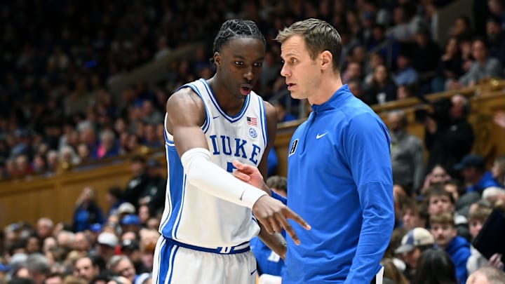 Jan 24, 2026; Durham, North Carolina, USA; Duke Blue Devils forward Dame Sarr (7) consults with head coach Jon Scheyer (right) during the first half against the Wake Forest Demon Deacons at Cameron Indoor Stadium.