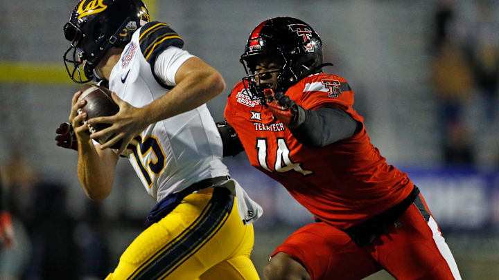 Dec 16, 2023; Shreveport, LA, USA; Texas Tech Red Raiders linebacker Joseph Adedire (14) sacks California Golden Bears quarterback Fernando Mendoza (15) during the second half at Independence Stadium. Mandatory Credit: Petre Thomas-USA TODAY Sports