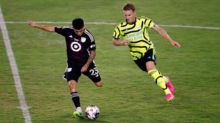 Thiago Almada and Martin Odegaard battle in the midfield