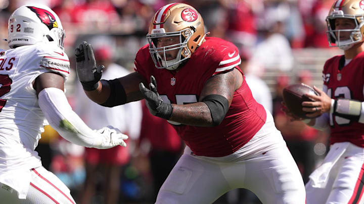 San Francisco 49ers guard Aaron Banks (center) blocks against Arizona Cardinals defensive tackle Bilal Nichols (left) during the second quarter at Levi's Stadium.
