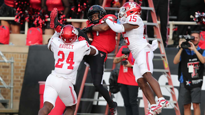 Sep 30, 2023; Lubbock, Texas, USA;  Texas Tech Red Raiders wide receiver Myles Price (1) catches a touchdown pass against Houston Cougars defensive back Malik Fleming (15) and defensive safety AJ Haulcy (24) in the second half at Jones AT&T Stadium and Cody Campbell Field. Mandatory Credit: Michael C. Johnson-Imagn Images