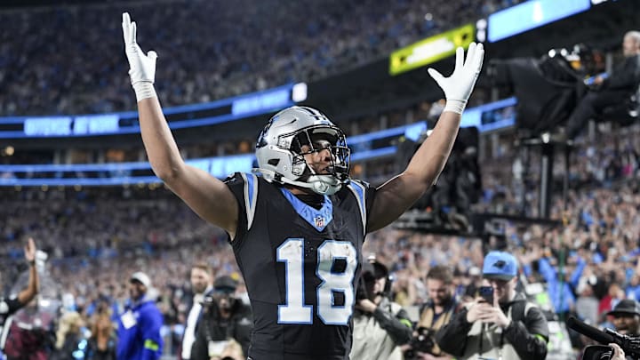 Jan 10, 2026; Charlotte, NC, USA;  Carolina Panthers wide receiver Jalen Coker (18) celebrates his score with fans during the second half of the NFC Wild Card Round game between the Carolina Panthers and the Los Angeles Rams at Bank of America Stadium. Mandatory Credit: Jim Dedmon-Imagn Images