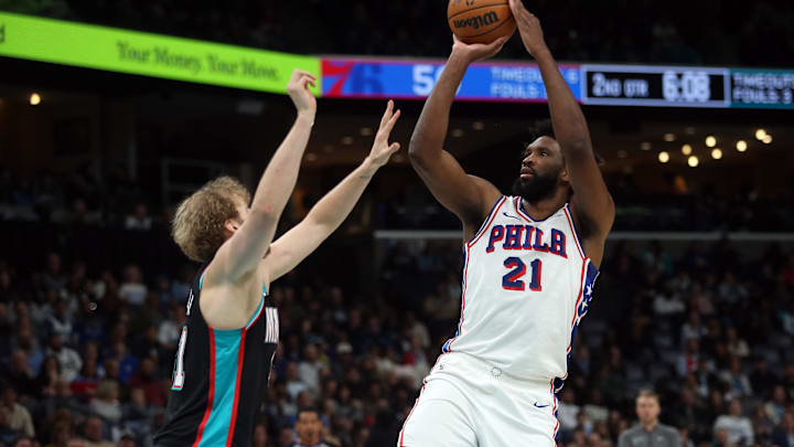 Dec 30, 2025; Memphis, Tennessee, USA; Philadelphia 76ers center Joel Embiid (21) shoots as Memphis Grizzlies center Jock Landale (31) defends during the second quarter at FedExForum. Mandatory Credit: Petre Thomas-Imagn Images