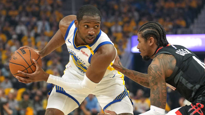 Apr 26, 2025; San Francisco, California, USA; Golden State Warriors forward Jonathan Kuminga (left) handles the ball against Houston Rockets guard Jalen Green (right) during the first quarter of game three of first round for the 2024 NBA Playoffs at Chase Center. Mandatory Credit: Darren Yamashita-Imagn Images