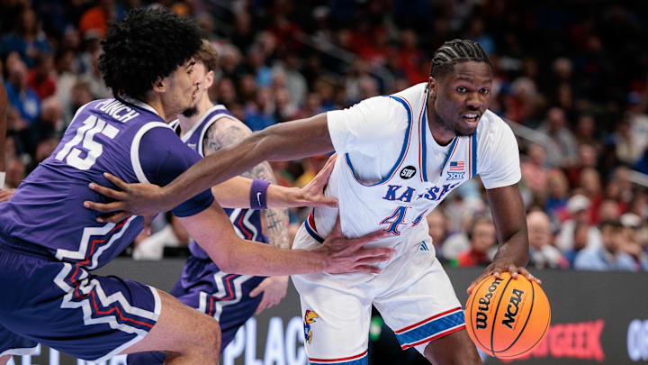 Mar 12, 2026; Kansas City, MO, USA; Kansas Jayhawks forward Flory Bidunga (40) drives to the basket around TCU Horned Frogs forward David Punch (15) during the first half at T-Mobile Center. Mandatory Credit: William Purnell-Imagn Images