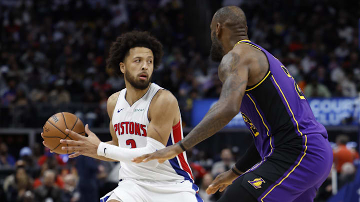 Nov 4, 2024; Detroit, Michigan, USA;  Detroit Pistons guard Cade Cunningham (2) is defended by Los Angeles Lakers forward LeBron James (23) in the second half at Little Caesars Arena. Mandatory Credit: Rick Osentoski-Imagn Images