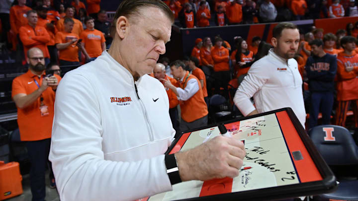 Feb 4, 2026; Champaign, Illinois, USA;  Illinois Fighting Illini head coach Brad Underwood prepares his game plan before tip-off against the Northwestern Wildcats at State Farm Center. Mandatory Credit: Ron Johnson-Imagn Images