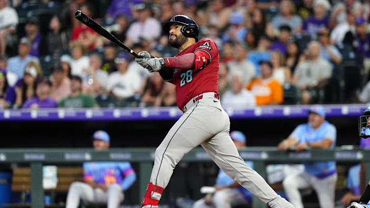 Jun 20, 2025; Denver, Colorado, USA; Arizona Diamondbacks third baseman Eugenio Suarez (28) hits a two run home run in the sixth inning against the Colorado Rockies at Coors Field. 