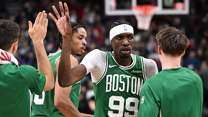 Oct 10, 2025; Toronto, Ontario, CAN: Boston Celtics forward Chris Boucher (99) slaps hands with team mates after making a basket against the Toronto Raptors in the first half at Scotiabank Arena. Mandatory Credit: Dan Hamilton-Imagn Images