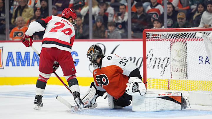 Dec 13, 2025; Philadelphia, Pennsylvania, USA; Philadelphia Flyers goalie Samuel Ersson (33) saves a shootout attempt against Carolina Hurricanes center Seth Jarvis (24) in overtime at Xfinity Mobile Arena. Mandatory Credit: Kyle Ross-Imagn Images