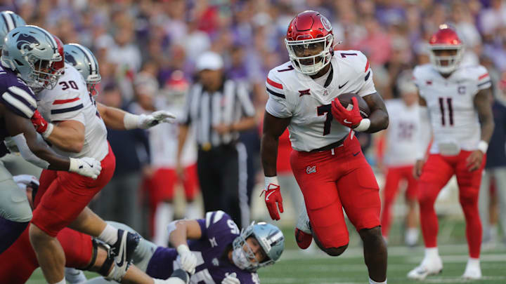 Arizona Wildcats running back Quali Conley (7) runs the ball during the first quarter of the game against Kansas State at Bill Snyder Family Stadium Friday, September 13, 2024.