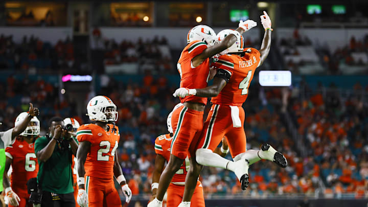 Sep 7, 2024; Miami Gardens, Florida, USA; Miami Hurricanes running back Mark Fletcher Jr. (4) celebrates with running back Jordan Lyle (21) after scoring against the Florida A&M Rattlers during the third quarter at Hard Rock Stadium. Mandatory Credit: Sam Navarro-Imagn Images