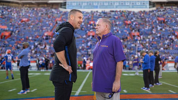 Nov 16, 2024; Gainesville, Florida, USA; Florida Gators head coach Billy Napier and LSU Tigers head coach Brian Kelly talk midfield before a game at Ben Hill Griffin Stadium. Photo by Matt Pendleton 