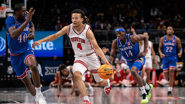 Mar 13, 2026; Kansas City, MO, USA; Houston Cougars guard Kingston Flemings (4) brings the ball up court around Kansas Jayhawks forward Flory Bidunga (40) during the first half at T-Mobile Center. Mar 13, 2026; Kansas City, MO, USA; Houston Cougars guard Kingston Flemings (4) brings the ball up court around Kansas Jayhawks forward Flory Bidunga (40) during the first half at T-Mobile Center.