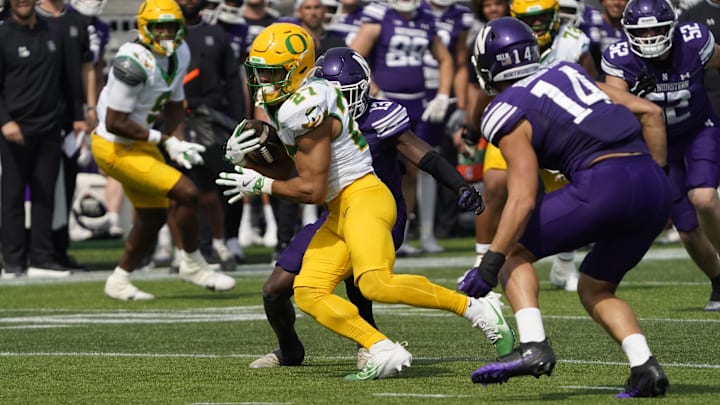 Sep 13, 2025; Evanston, Illinois, USA; Oregon Ducks running back Jayden Limar (27) runs against the Northwestern Wildcats during the first half at Northwestern Medicine Field at Martin Stadium. Mandatory Credit: David Banks-Imagn Images