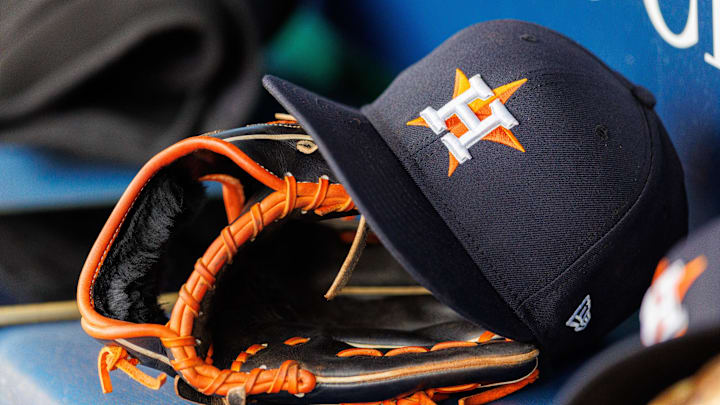 Apr 27, 2025; Kansas City, Missouri, USA; Houston Astros hat and glove in the dugout during the second inning against the Kansas City Royals at Kauffman Stadium.