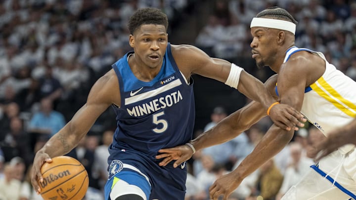 May 8, 2025; Minneapolis, Minnesota, USA; Minnesota Timberwolves guard Anthony Edwards (5) dribbles the ball past Golden State Warriors forward Jimmy Butler III (10) in the first half during game two of the second round for the 2025 NBA Playoffs at Target Center. Mandatory Credit: Jesse Johnson-Imagn Images