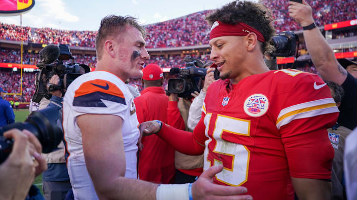 Nov 10, 2024; Kansas City, Missouri, USA; Denver Broncos quarterback Bo Nix (10) talks with Kansas City Chiefs quarterback Patrick Mahomes (15) after the game at GEHA Field at Arrowhead Stadium.