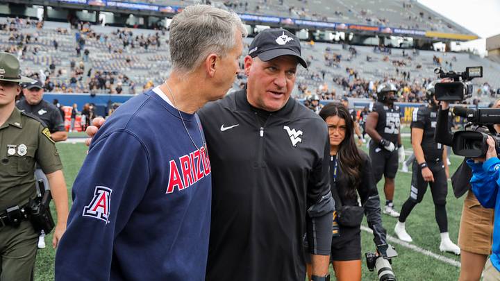 Oct 10, 2026; Morgantown, West Virginia, USA; West Virginia Mountaineers head coach Rich Rodriguez talks to Arizona Wildcats head coach Brent Brennan after the game at Milan Puskar Stadium. Mandatory Credit: Ben Queen-Imagn Images Oct 10, 2026; Morgantown, West Virginia, USA; West Virginia Mountaineers head coach Rich Rodriguez talks to Arizona Wildcats head coach Brent Brennan after the game at Milan Puskar Stadium. Mandatory Credit: Ben Queen-Imagn Images