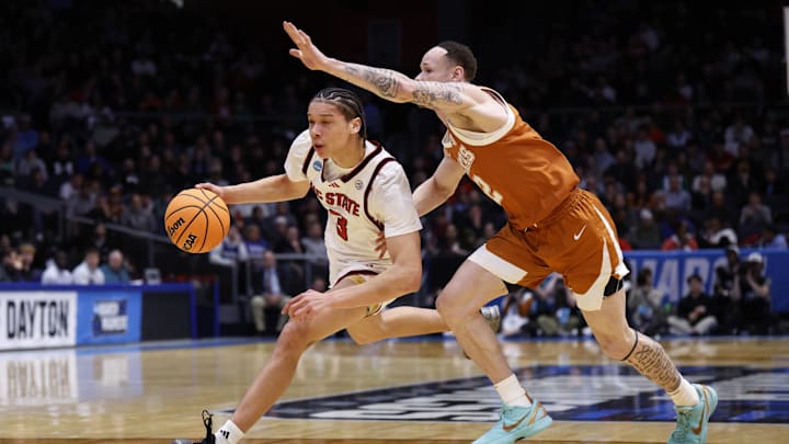 NC State Wolfpack guard Matt Able dribbles the ball while defended by Texas Longhorns guard Chendall Weaver in the first half during a First Four game of the men's 2026 NCAA Tournament at University of Dayton Arena.