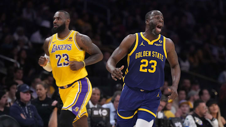 Apr 9, 2024; Los Angeles, California, USA; Golden State Warriors forward Draymond Green (right) and Los Angeles Lakers forward LeBron James react in the first half at Crypto.com Arena. Mandatory Credit: Kirby Lee-Imagn Images