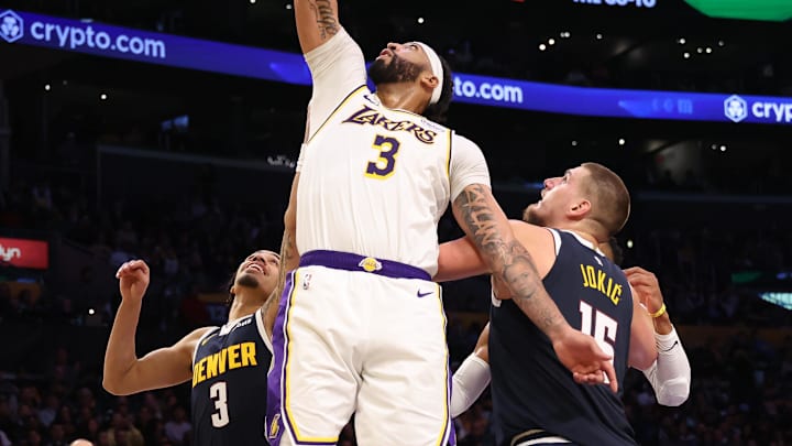 Nov 23, 2024; Los Angeles, California, USA; Los Angeles Lakers center Anthony Davis (3) shoots the ball between Denver Nuggets guard Julian Strawther (3) and center Nikola Jokic (15) during the third quarter at Crypto.com Arena. Mandatory Credit: Kiyoshi Mio-Imagn Images Nov 23, 2024; Los Angeles, California, USA; Los Angeles Lakers center Anthony Davis (3) shoots the ball between Denver Nuggets guard Julian Strawther (3) and center Nikola Jokic (15) during the third quarter at Crypto.com Arena. Mandatory Credit: Kiyoshi Mio-Imagn Images