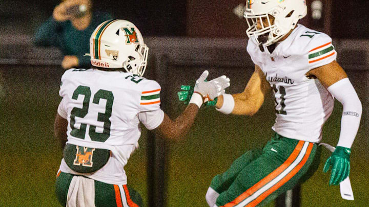 Mandarin Mustangs running back Shaunqueze Foster (23) congratulates Mandarin Mustangs wide receiver Brysen Wright (11) after his touchdown in the second half. The Bradford Tornadoes hosted the Mandarin Mustangs at David Hurse Stadium at Bradford High School in Starke, FL on Friday, September 13, 2024. The Mustangs lead 13-6 at the beginning of the fourth quarter.[Doug Engle/Ocala Star Banner]
