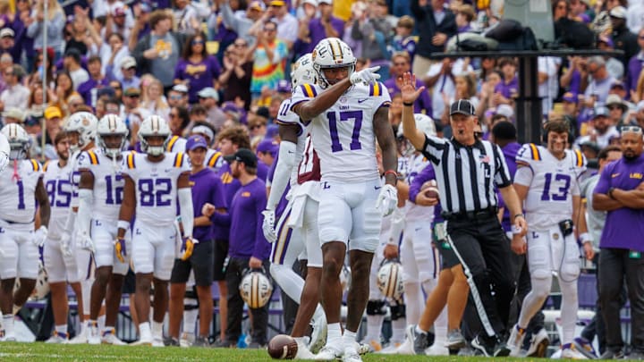 Nov 25, 2023; Baton Rouge, Louisiana, USA;  LSU Tigers wide receiver Chris Hilton Jr. (17) points to the student section after catching a 25 yard pass against Texas A&M Aggies defensive back Deuce Harmon (11) during the second half at Tiger Stadium. Mandatory Credit: Stephen Lew-Imagn Images