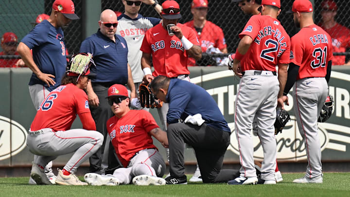 Feb 27, 2026; North Port, Florida, USA; Members of the Boston Red Sox staff check on left fielder Roman Anthony (19) and center fielder Ceddanne Rafaela (3) after a collision in the first inning against the Atlanta Braves during spring training at CoolToday Park. Mandatory Credit: Jonathan Dyer-Imagn Images