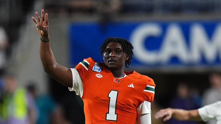 Dec 28, 2024; Orlando, FL, USA; Miami Hurricanes quarterback Cam Ward (1) gestures during the second half against the Iowa State Cyclones  at Camping World Stadium. Mandatory Credit: Jasen Vinlove-Imagn Images