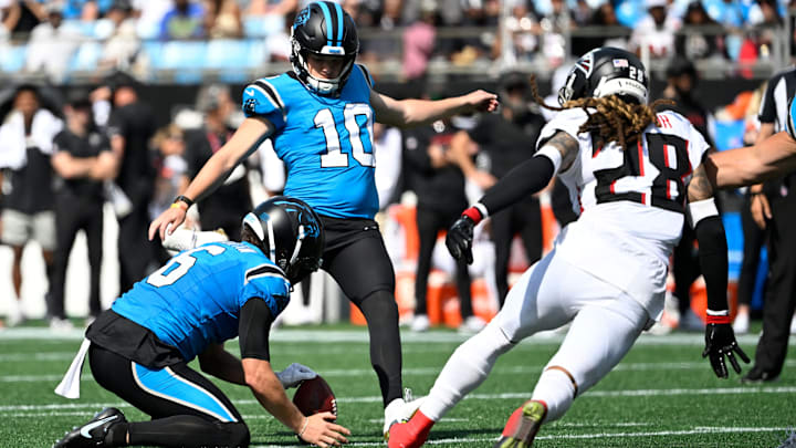 Sep 21, 2025; Charlotte, North Carolina, USA; Carolina Panthers kicker Ryan Fitzgerald (10) kicks a field goal as Atlanta Falcons cornerback Mike Ford (28) defends in the third quarter at Bank of America Stadium. 