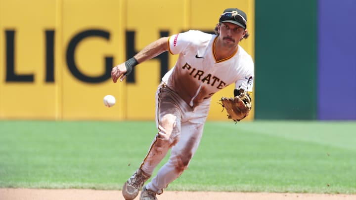 Jun 29, 2025; Pittsburgh, Pennsylvania, USA;  Pittsburgh Pirates second baseman Adam Frazier (26) fields a ground ball for an out against New York Mets third baseman Brett Baty (not pictured) during the fifth inning at PNC Park. Mandatory Credit: Charles LeClaire-Imagn Images