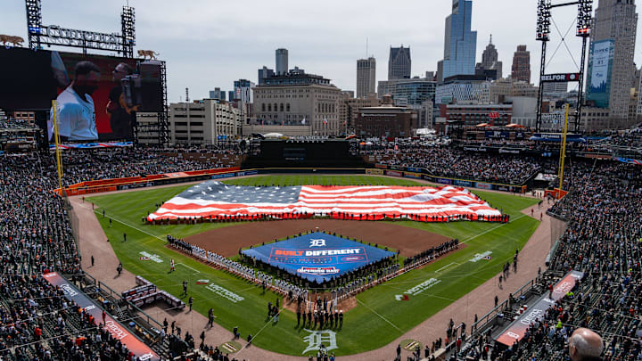 Hundreds of fans stand for the Pledge of Allegiance before the start of the Detroit Tigers’ Opening Day game against the Chicago White Sox at Comerica Park in Detroit on Friday, April 4, 2025.