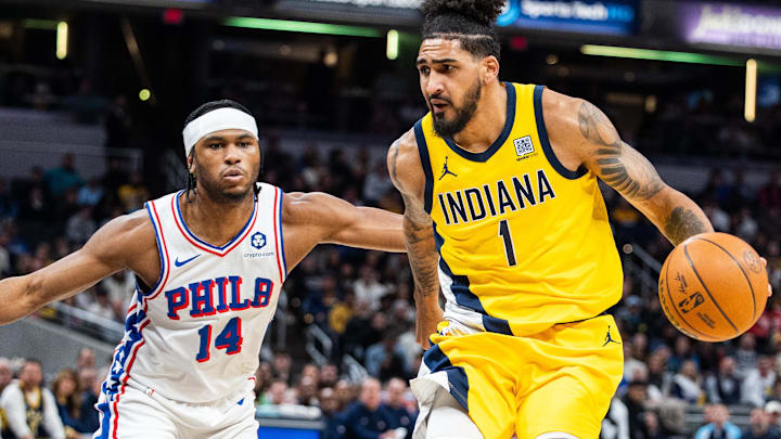 Jan 18, 2025; Indianapolis, Indiana, USA; Indiana Pacers forward Obi Toppin (1) dribbles the ball while Philadelphia 76ers guard Ricky Council IV (14) defends in the first half at Gainbridge Fieldhouse. Mandatory Credit: Trevor Ruszkowski-Imagn Images