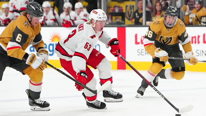 Nov 11, 2024; Las Vegas, Nevada, USA; Carolina Hurricanes right wing Jackson Blake (53) controls the puck ahead of Vegas Golden Knights defenseman Kaedan Korczak (6) during the first period at T-Mobile Arena. Mandatory Credit: Stephen R. Sylvanie-Imagn Images