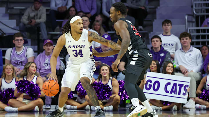 Feb 11, 2026; Manhattan, Kansas, USA; Kansas State Wildcats guard Nate Johnson (34) is guarded by Cincinnati Bearcats guard Jalen Celestine (32) during the first half at Bramlage Coliseum. 