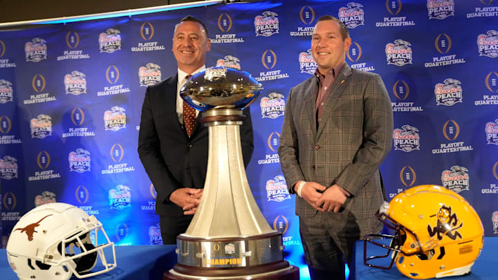 Texas head coach Steve Sarkisian and Arizona State head coach Kenny Dillingham pose for photos before facing off in the Chick-fil-A Peach Bowl.