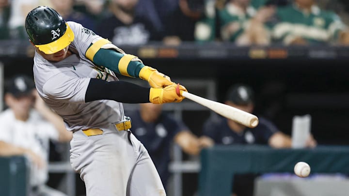 Sep 14, 2024; Chicago, Illinois, USA; Oakland Athletics outfielder Brent Rooker (25) hits a two-run single against the Chicago White Sox during the sixth inning at Guaranteed Rate Field. Mandatory Credit: Kamil Krzaczynski-Imagn Images