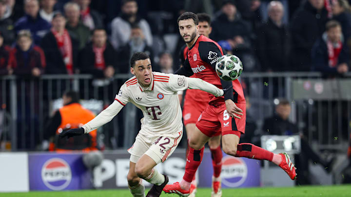 Jamal Musiala of Bayern Munich (L) and Mario Hermoso of...