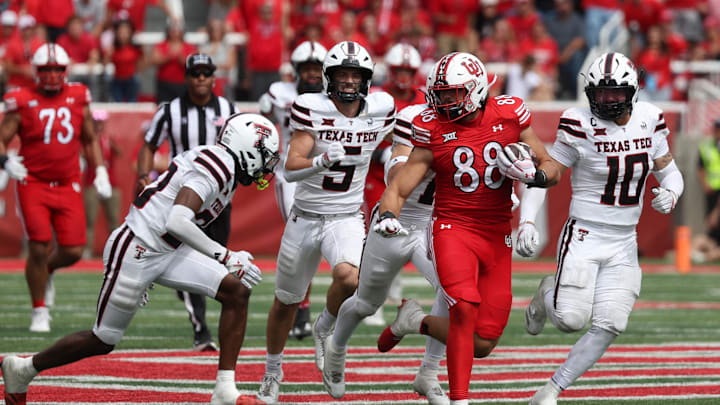 Utah Utes tight end Dallen Bentley (88) runs after a catch against Texas Tech Red Raiders defensive back Dontae Balfour (20) and linebacker Jacob Rodriguez (10) during the fourth quarter at Rice-Eccles Stadium. Utah Utes tight end Dallen Bentley (88) runs after a catch against Texas Tech Red Raiders defensive back Dontae Balfour (20) and linebacker Jacob Rodriguez (10) during the fourth quarter at Rice-Eccles Stadium.