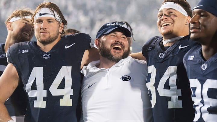 Penn State tight ends coach Ty Howle (center) puts his arms around tight ends Tyler Warren (44) and Theo Johnson (84) following a 31-0 win over Iowa in 2023. Penn State tight ends coach Ty Howle (center) puts his arms around tight ends Tyler Warren (44) and Theo Johnson (84) following a 31-0 win over Iowa in 2023.