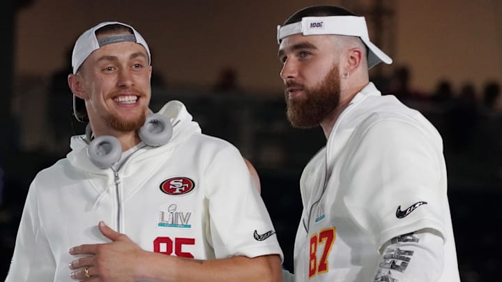 San Francisco 49ers tight end George Kittle (85) greets Kansas City Chiefs tight end Travis Kelce (87) during Super Bowl LIV Opening Night at Marlins Park.