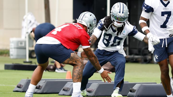 Dallas Cowboys quarterback Dak Prescott celebrates with wide receiver CeeDee Lamb during a minicamp drill.