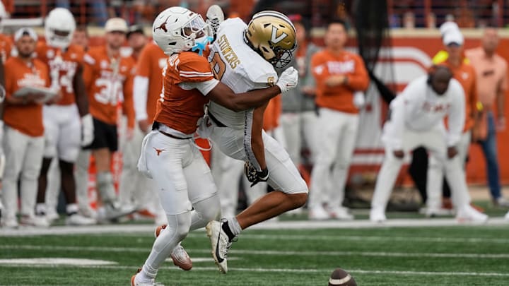 Nov 1, 2025; Austin, Texas, USA; Texas Longhorns defensive back Malik Muhammad (5) breaks up a pass intended for Vanderbilt Commodores tight end Eli Stowers (9) during the second half at Darrell K Royal-Texas Memorial Stadium. Mandatory Credit: Scott Wachter-Imagn Images