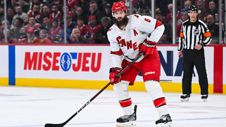 Apr 16, 2025; Montreal, Quebec, CAN; Carolina Hurricanes defenseman Brent Burns (8) considers his options with the puck against the Montreal Canadiens in the second period at Bell Centre. Mandatory Credit: David Kirouac-Imagn Images