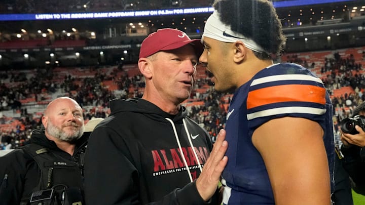 Nov 29, 2025; Auburn, Alabama, USA; Alabama head coach Kalen DeBoer talks to Auburn quarterback Ashton Daniels (12) after Alabama defeated Auburn at Jordan-Hare Stadium. Mandatory Credit: Gary Cosby Jr.-Tuscaloosa News