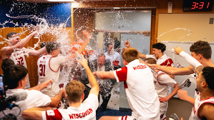 Wisconsin players douse head coach Greg Gard (center) with water after the Badgers beat No.2 Michigan, 91-88, in Ann Arbor on January 10, 2026.