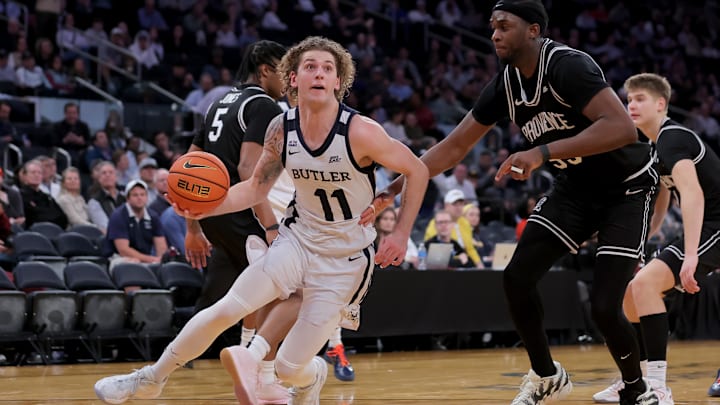 Mar 11, 2026; New York, NY, USA; Butler Bulldogs guard Finley Bizjack (11) drives to the basket against Providence Friars forward Oswin Erhunmwunse (55) during the second half at Madison Square Garden. Mandatory Credit: Brad Penner-Imagn Images